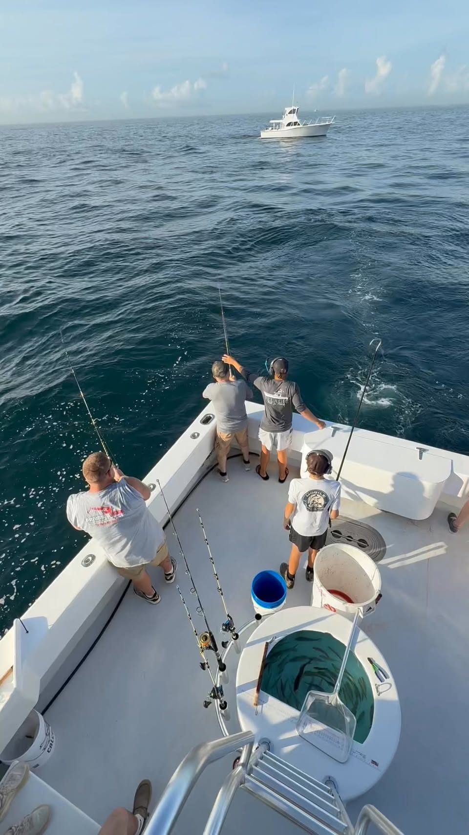 Anglers fishing off the stern in golden morning light